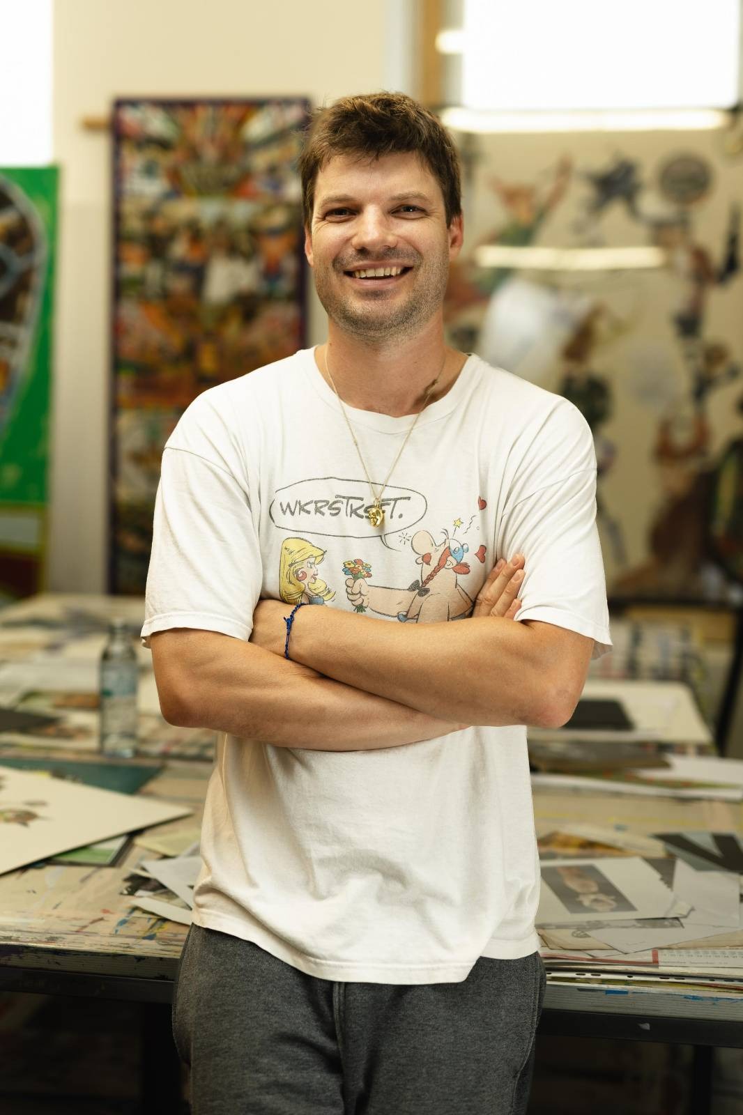 young artist in white t-shirt and crossed arms